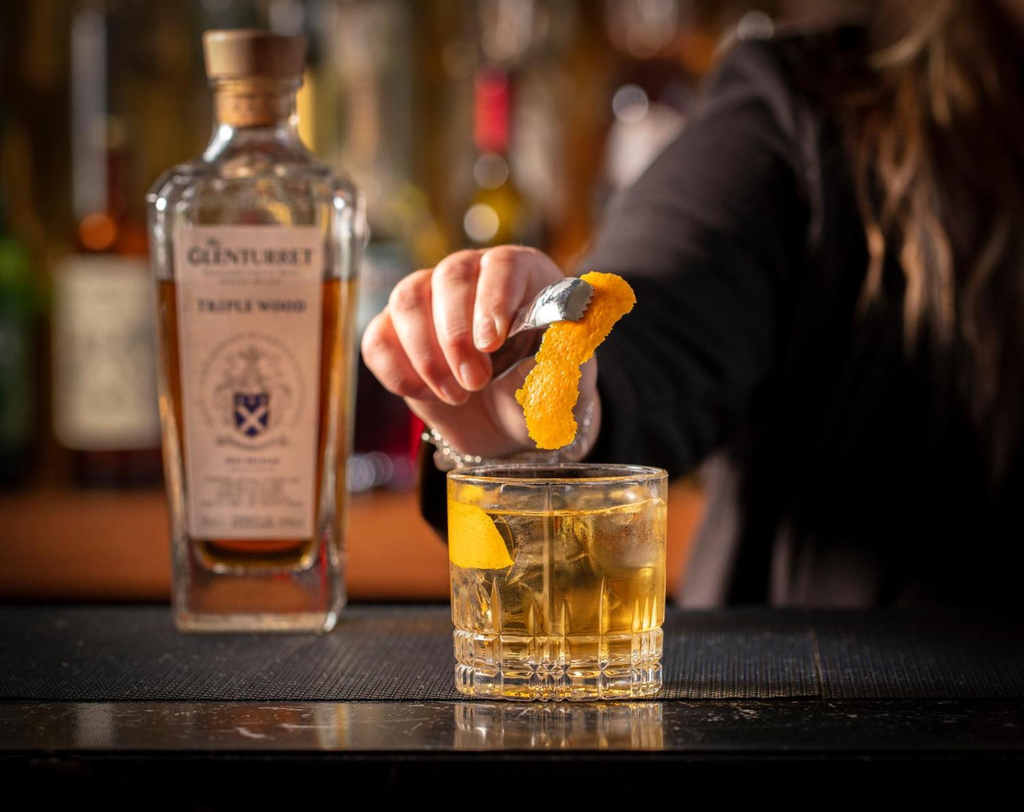 Schloss Roxburghe, Part Of Destination By Hyatt Dış mekan fotoğraf A bartender adding a lemon twist to a glass of GINfinity