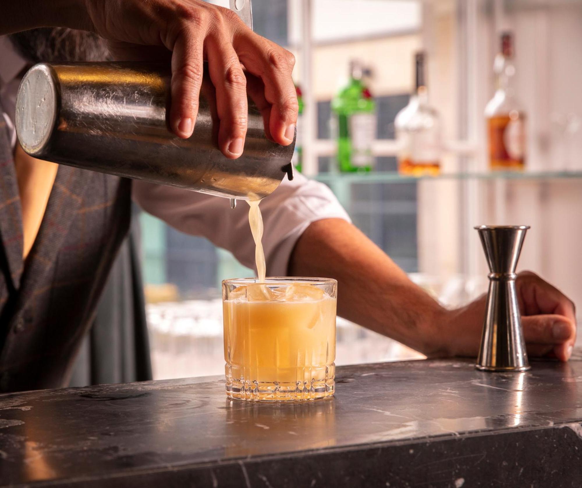 Schloss Roxburghe, Part Of Destination By Hyatt Dış mekan fotoğraf A bartender straining a cocktail
